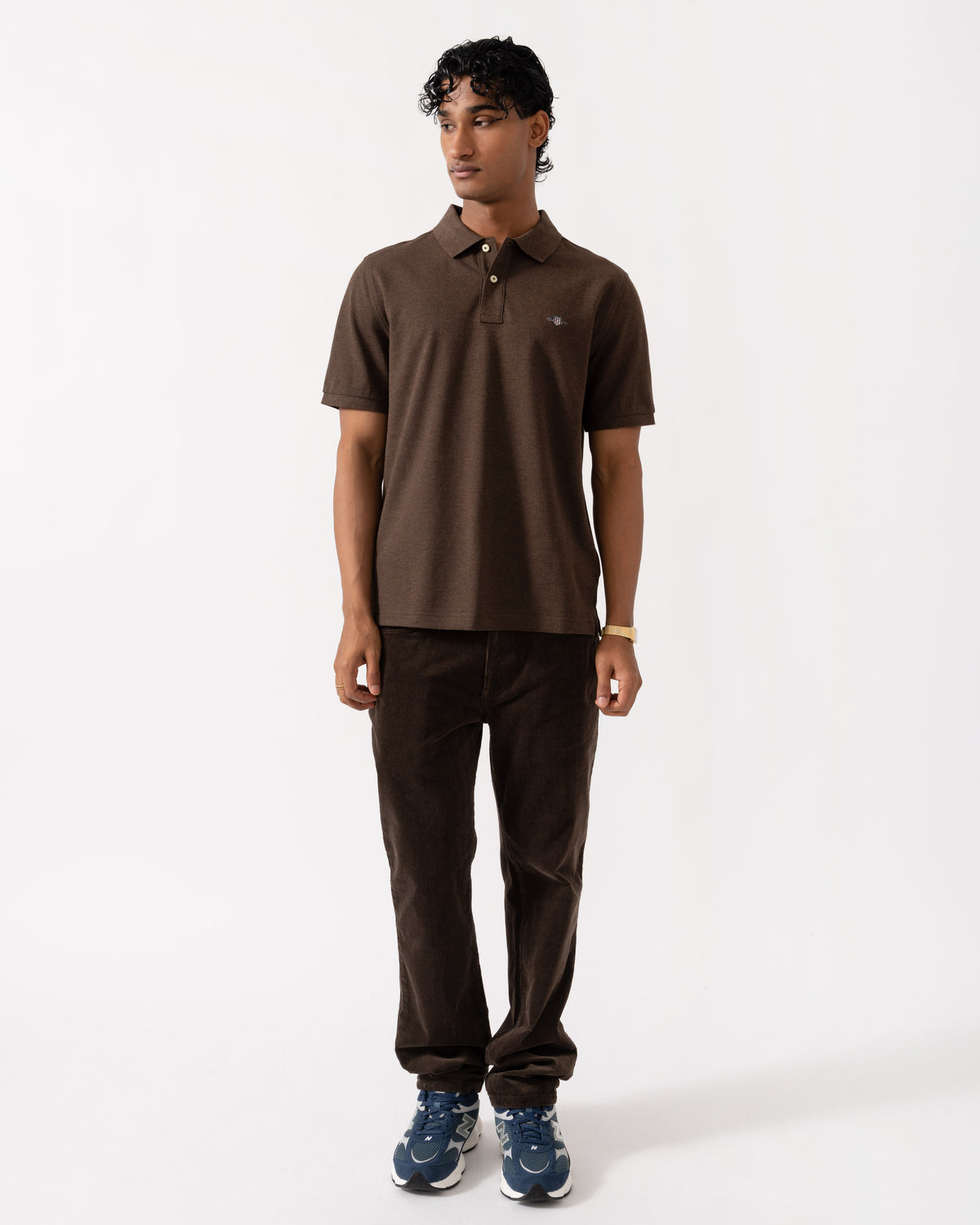 Man wearing the GANT Mens Regular Fit Short Sleeve Shield Logo Pique Polo - 284 Black Brown Melange