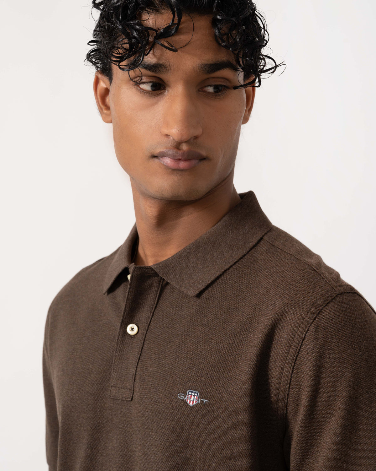 Close up of the GANT Mens Regular Fit Short Sleeve Shield Logo Pique Polo - 284 Black Brown Melange