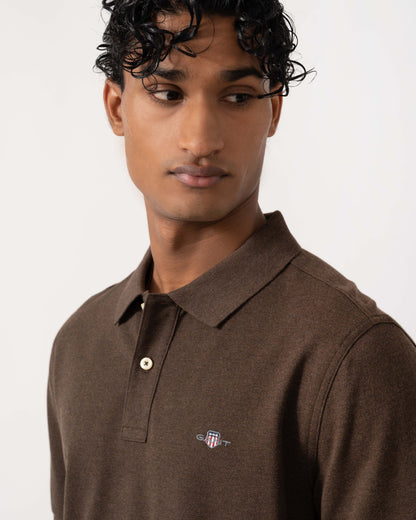 Close up of the GANT Mens Regular Fit Short Sleeve Shield Logo Pique Polo - 284 Black Brown Melange