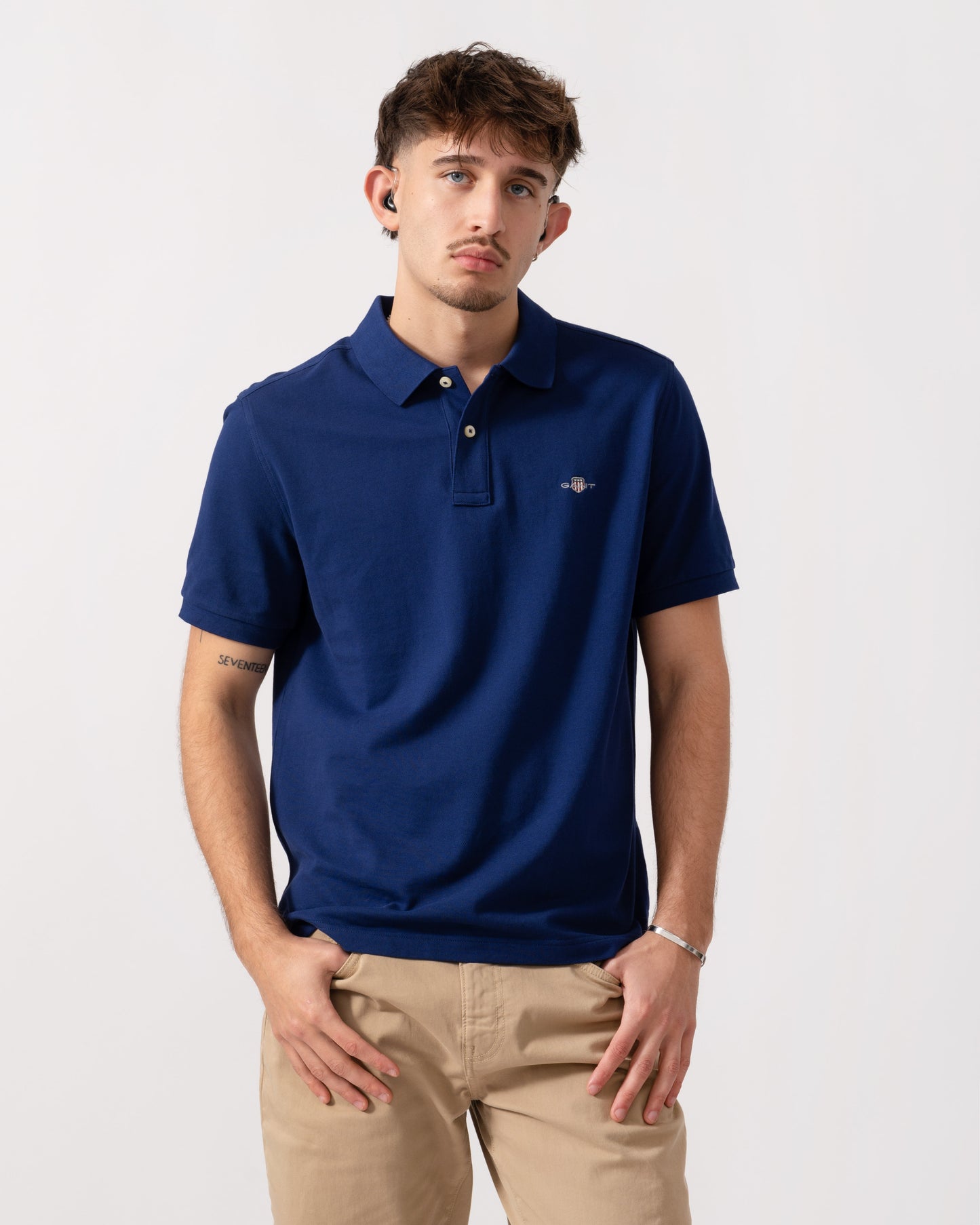 Model wearing GANT Mens Regular Fit Short Sleeve Shield Logo Pique Polo in 432 Rich Navy - Front