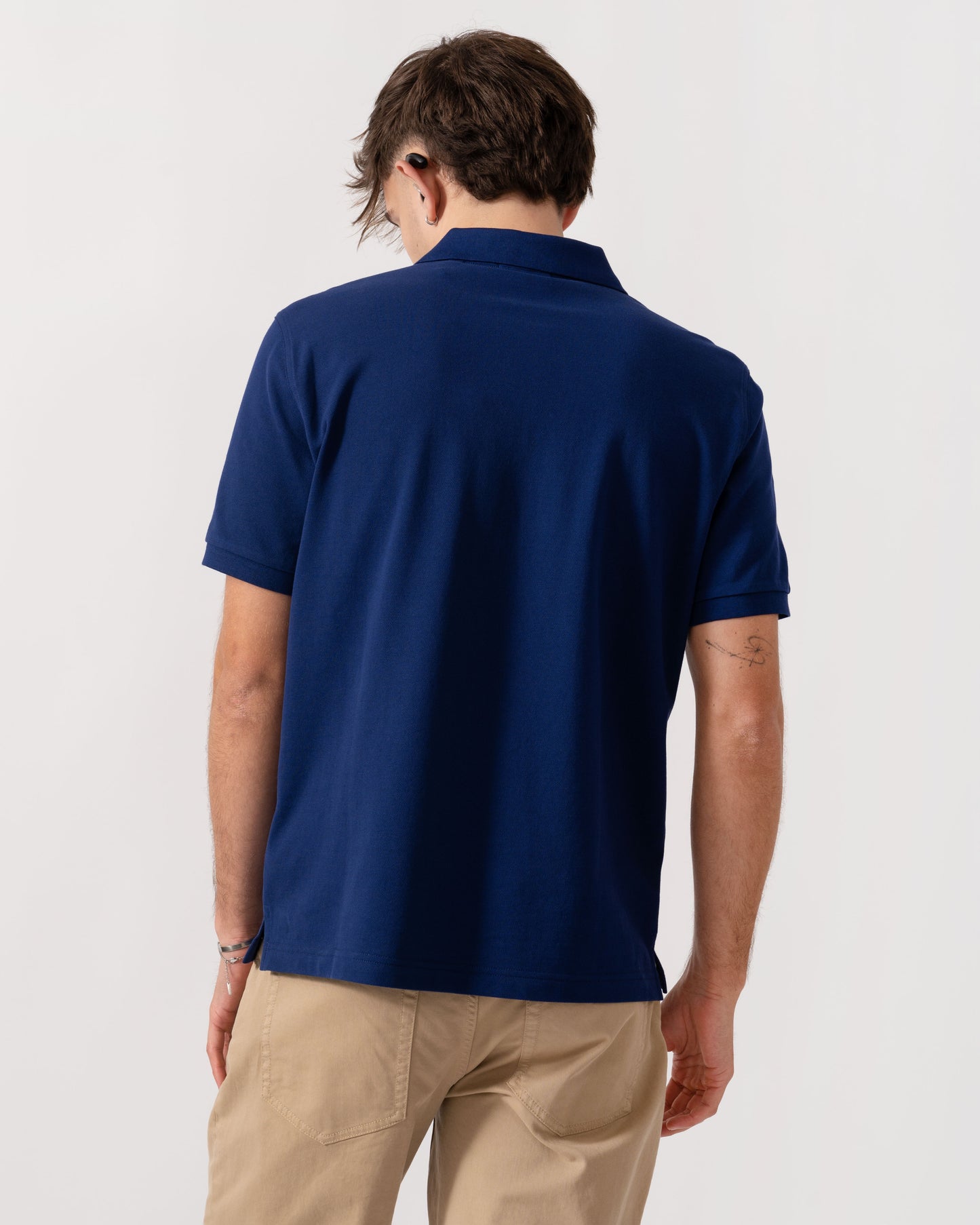 Model wearing GANT Mens Regular Fit Short Sleeve Shield Logo Pique Polo in 432 Rich Navy - Back