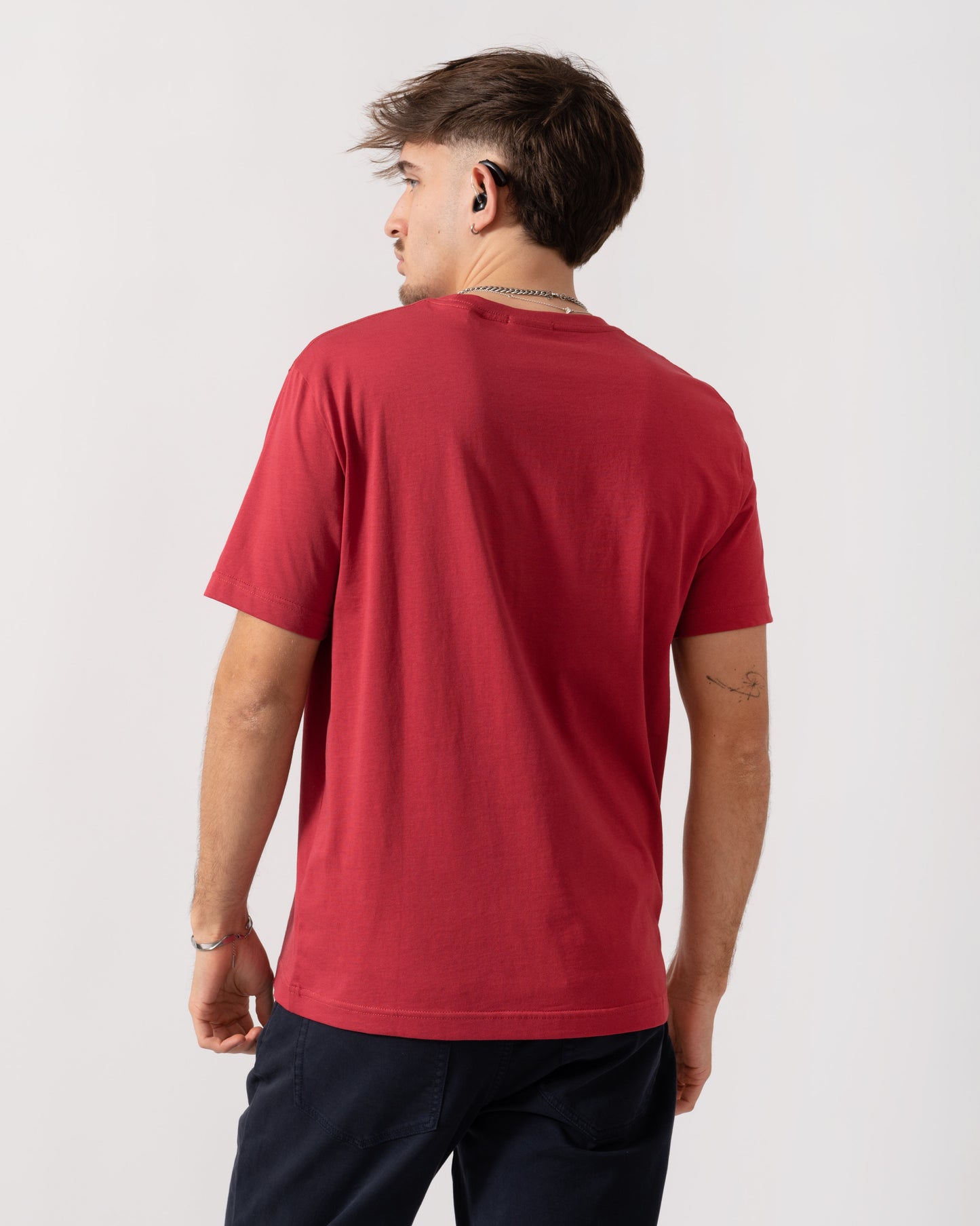 Person wearing a red t-shirt on a white background