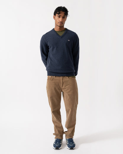 Man wearing the GANT Mens Superfine Lambswool V-Neck Sweater - 480 Dark Navy Melange