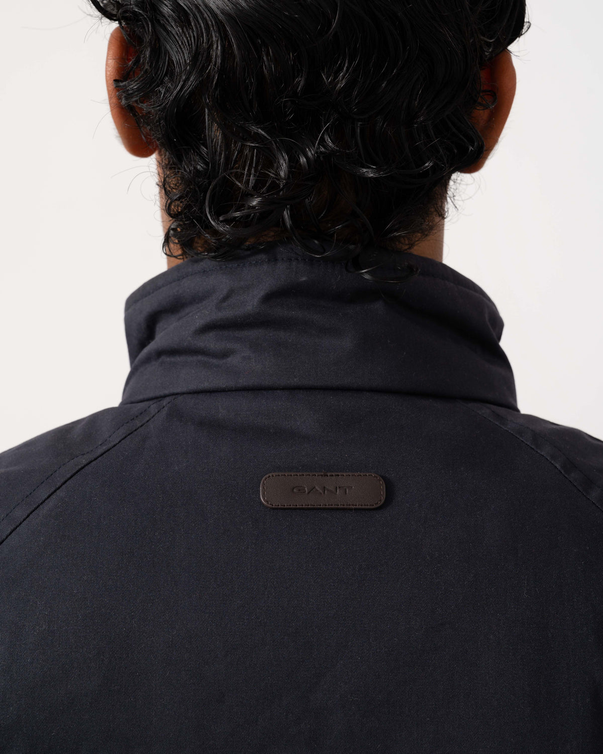 Logo on the collar of the GANT Mens Waxed Double Decker Coat - 433 Evening Blue