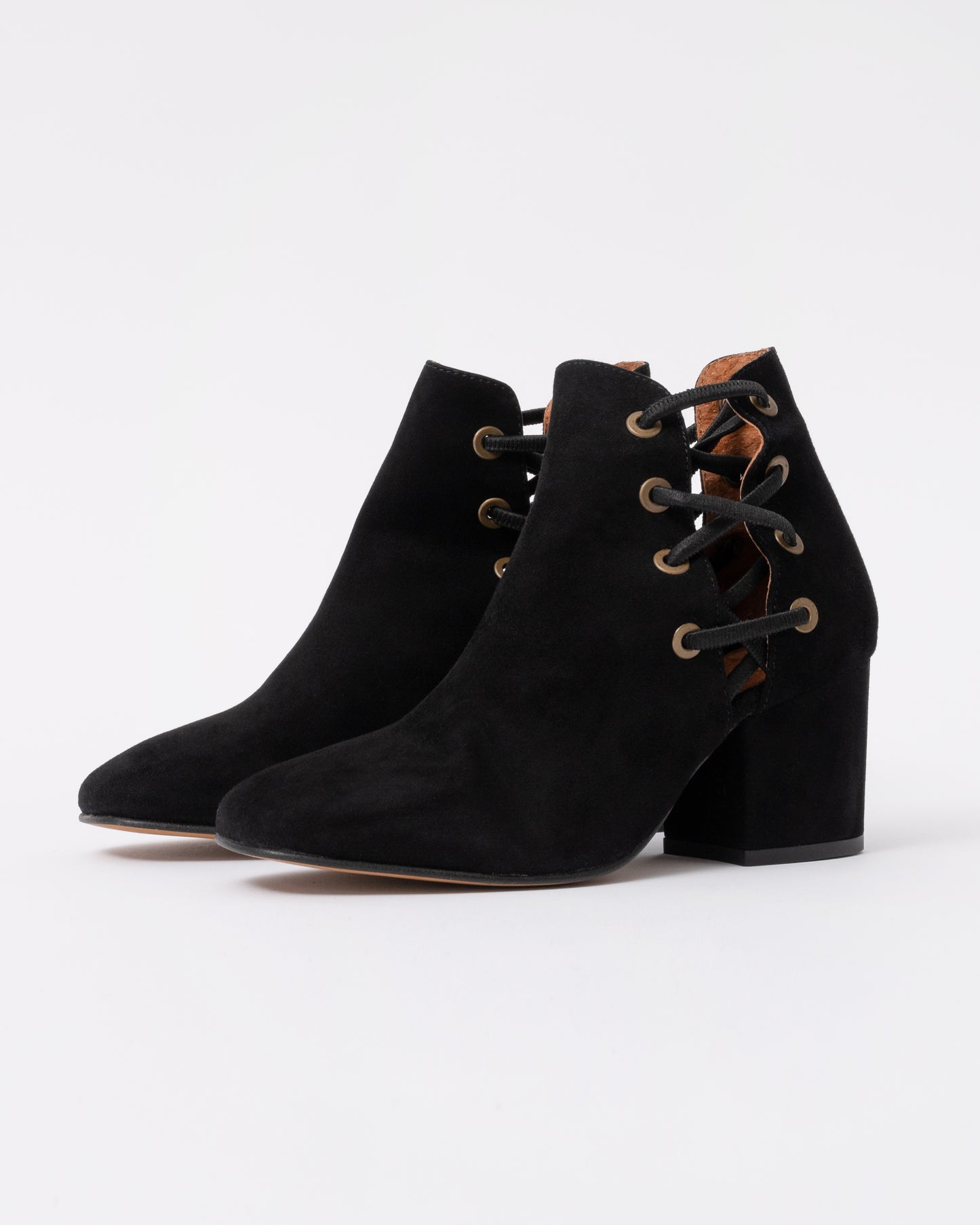 Black suede ankle boots with a block heel on a white background