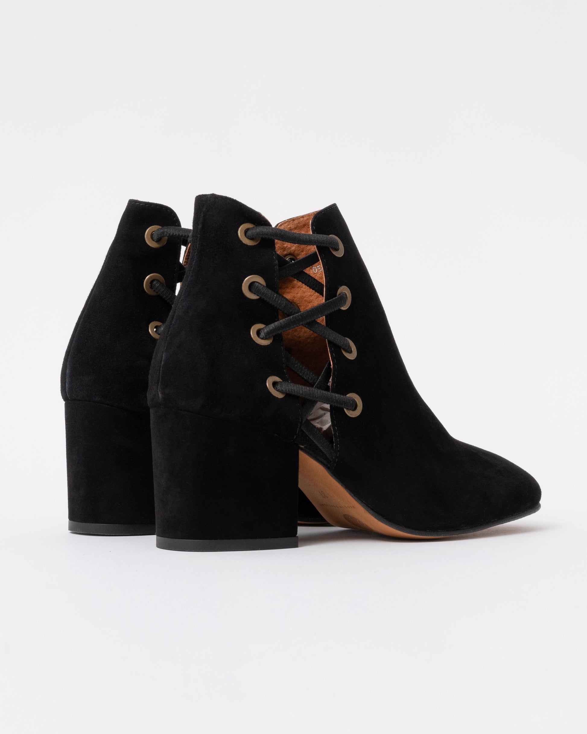 Black suede ankle boots with block heels on a white background