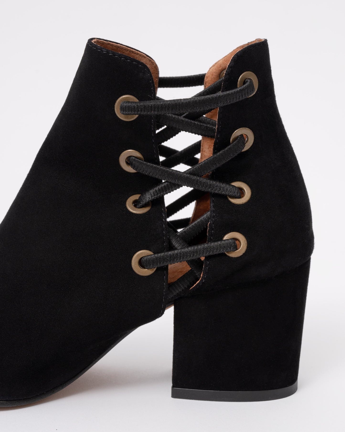 Black suede lace-up boots with a block heel on a white background