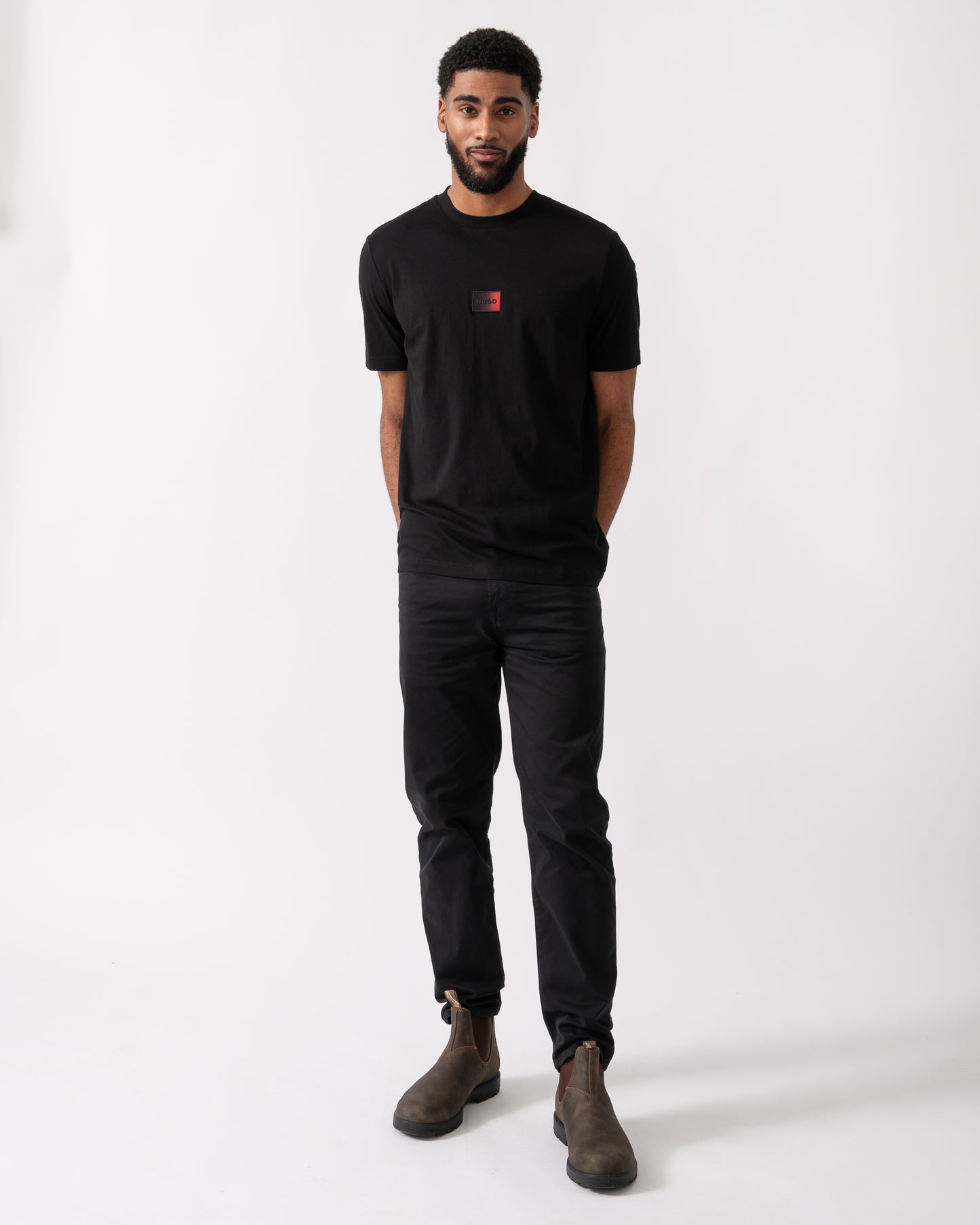 full length shot of a model wearing a HUGO Danotie Mens Red Label Logo T-Shirt in Black