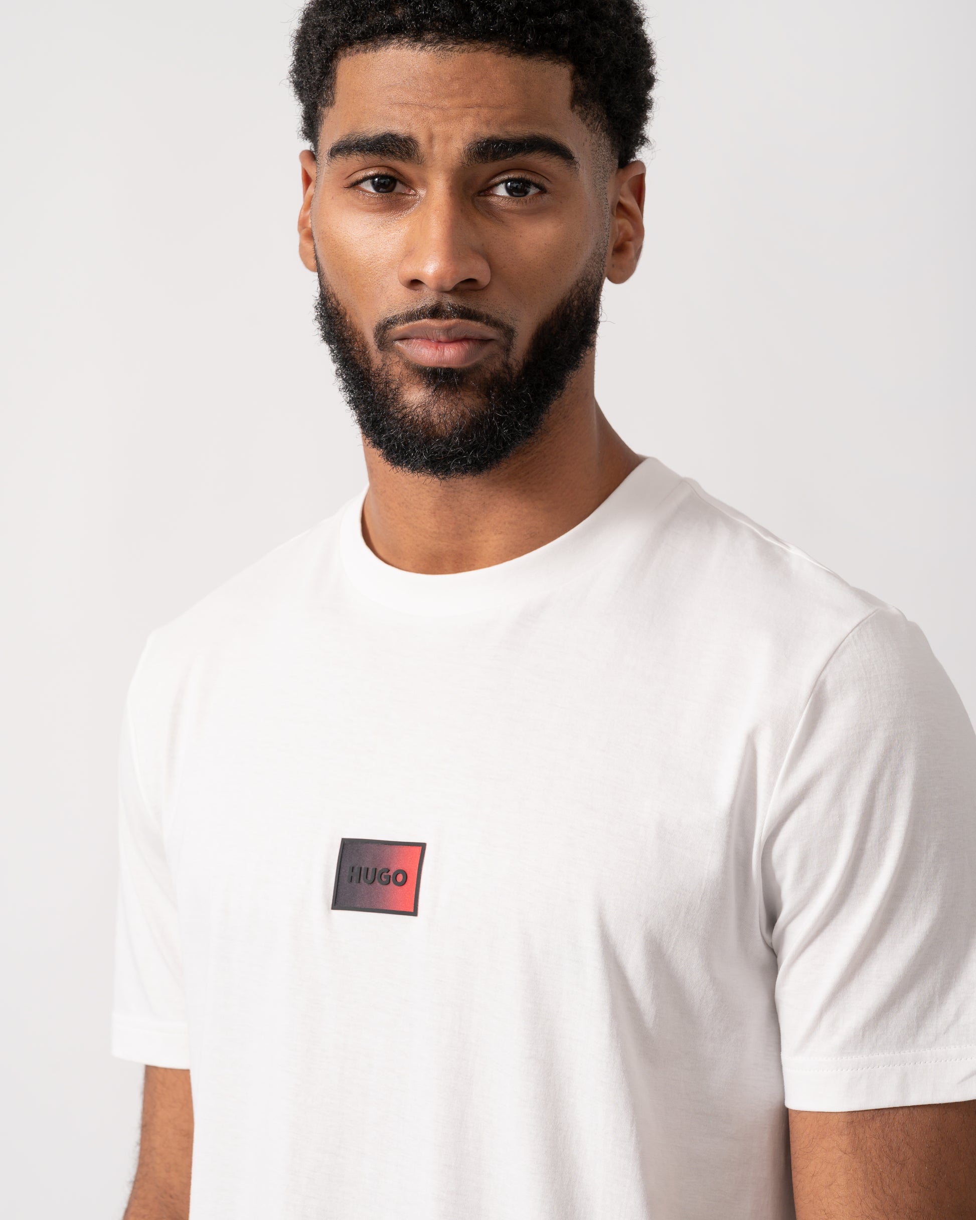 close up of a model wearing a HUGO Danotie Mens Red Label Logo T-Shirt in natural white