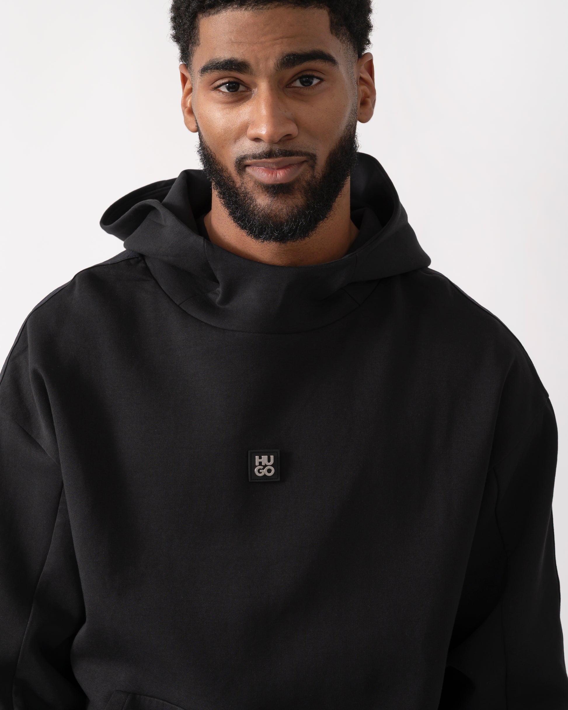 detail shot of a model wearing a HUGO Danovohood Mens Hoodie in Black