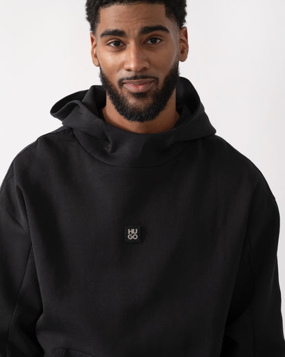 detail shot of a model wearing a HUGO Danovohood Mens Hoodie in Black