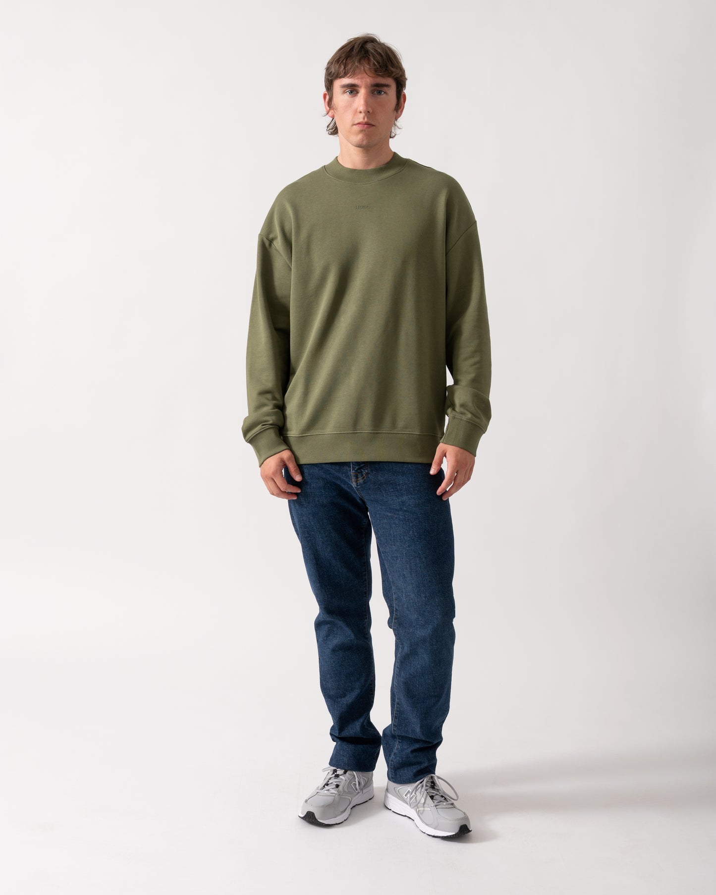 full length shot of a model wearing a HUGO Dapocrew Mens Crew Neck Sweatshirt in Open Green 388