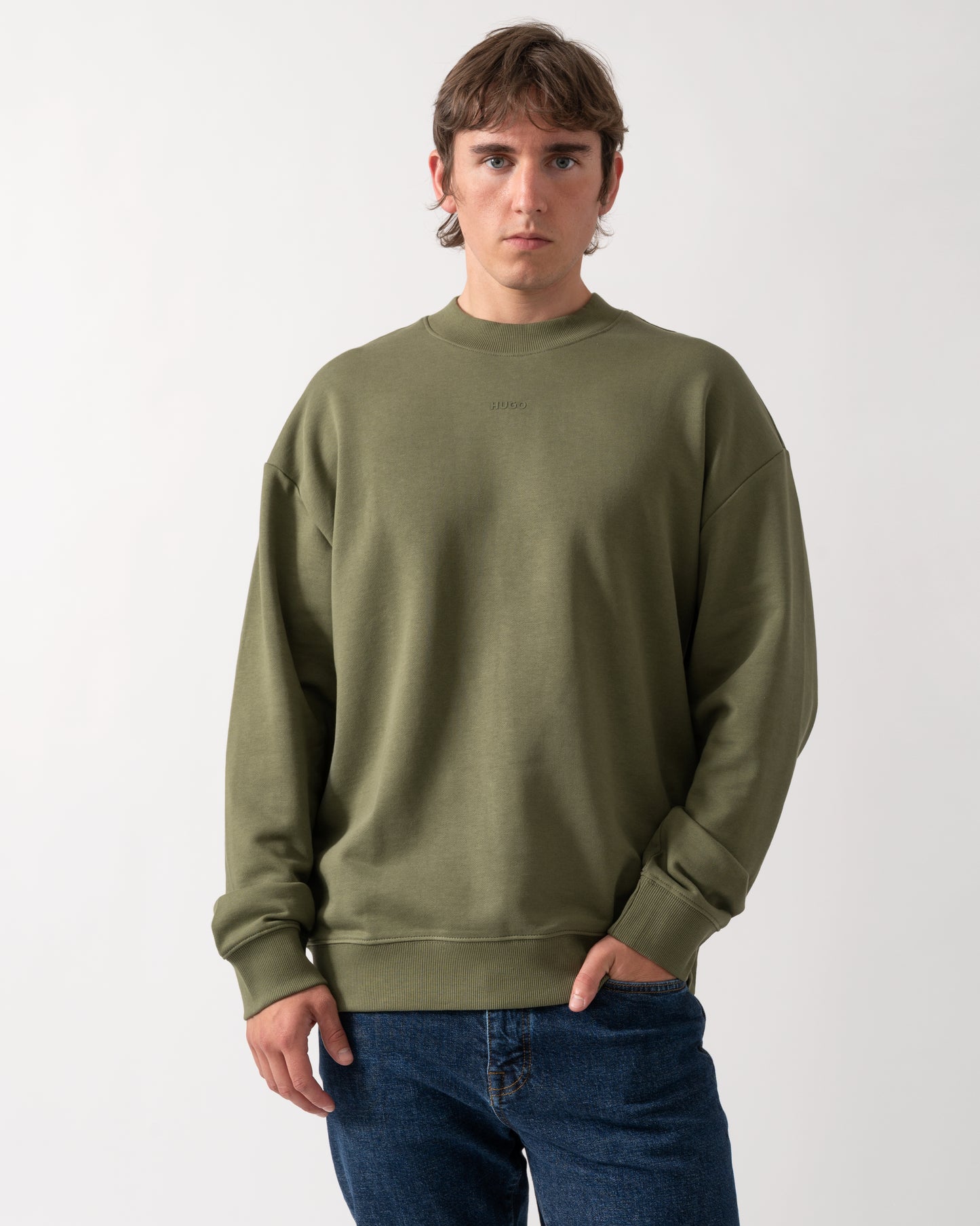 model wearing a HUGO Dapocrew Mens Crew Neck Sweatshirt in Open Green 388
