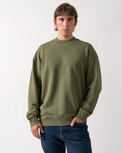 model wearing a HUGO Dapocrew Mens Crew Neck Sweatshirt in Open Green 388