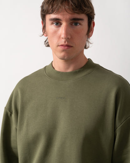 close up  shot of a model wearing a HUGO Dapocrew Mens Crew Neck Sweatshirt in Open Green 388