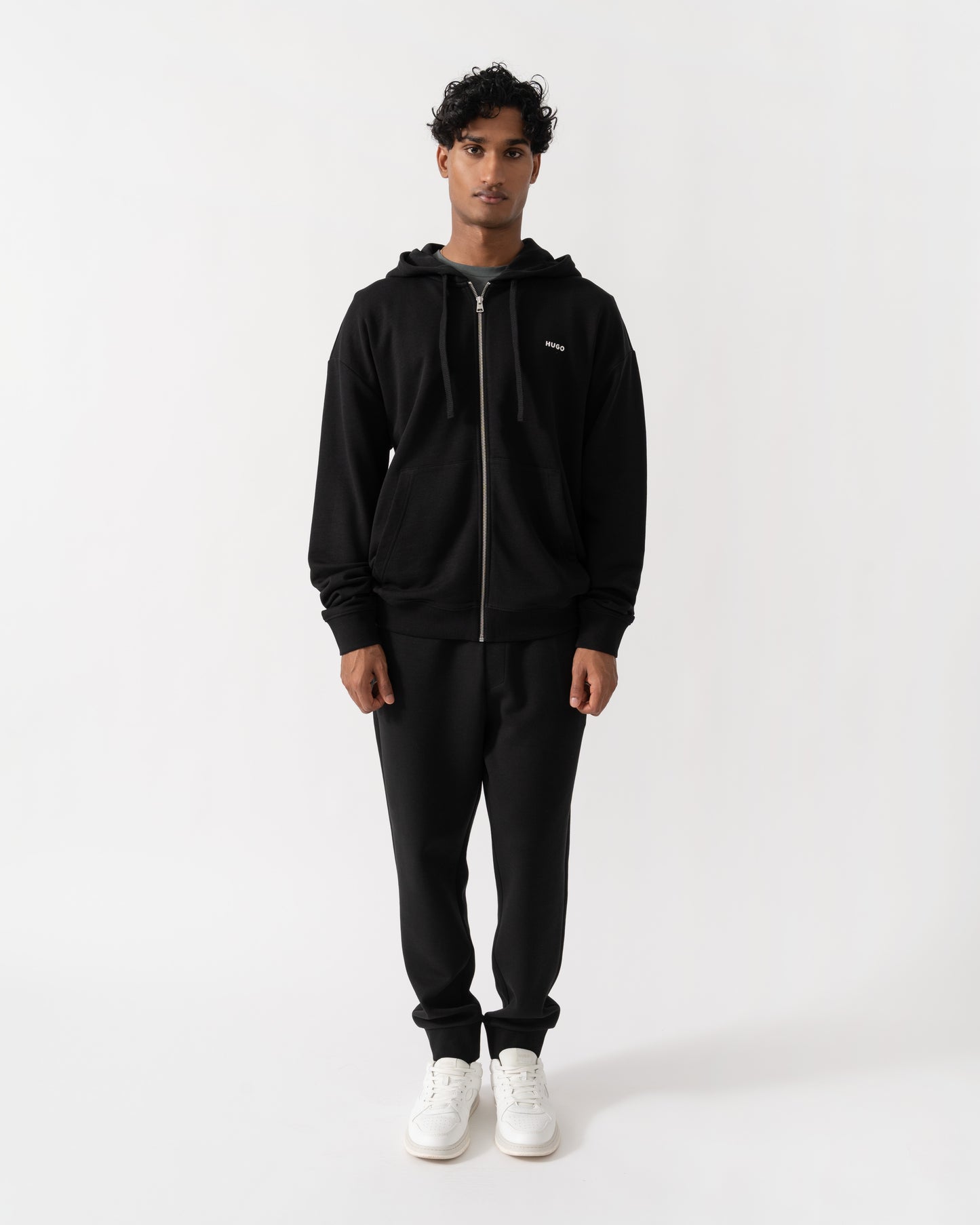 Man wearing HUGO Dapozip Mens Cotton-terry zip-up hoodie with logo print - Black 001