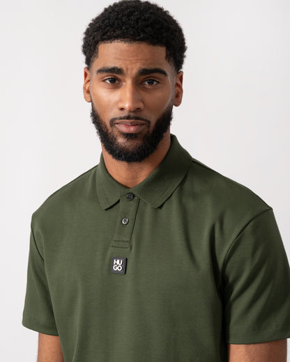 close up of a model wearing a HUGO Deabono Mens Interlock Cotton Polo Shirt with Stacked Logo in Dark Green