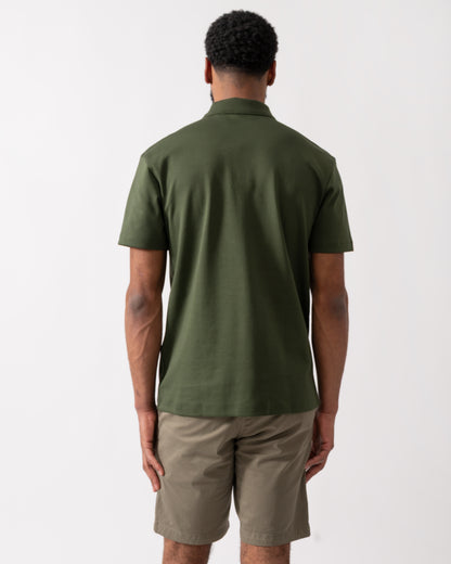 back of a model wearing a HUGO Deabono Mens Interlock Cotton Polo Shirt with Stacked Logo in Dark Green