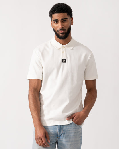model wearing a HUGO Deabono Mens Interlock Cotton Polo Shirt with Stacked Logo in Natural white