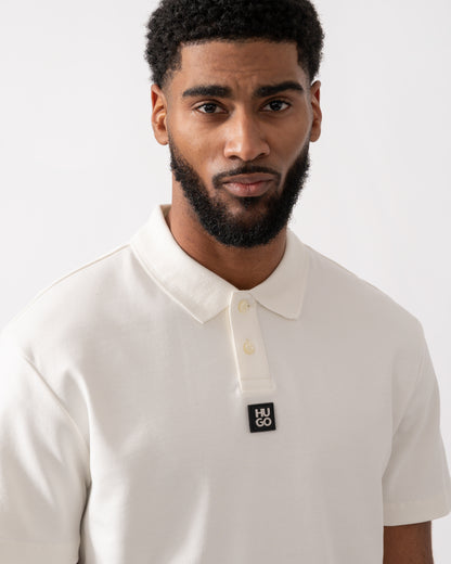 close up of a model wearing a HUGO Deabono Mens Interlock Cotton Polo Shirt with Stacked Logo in Natural white