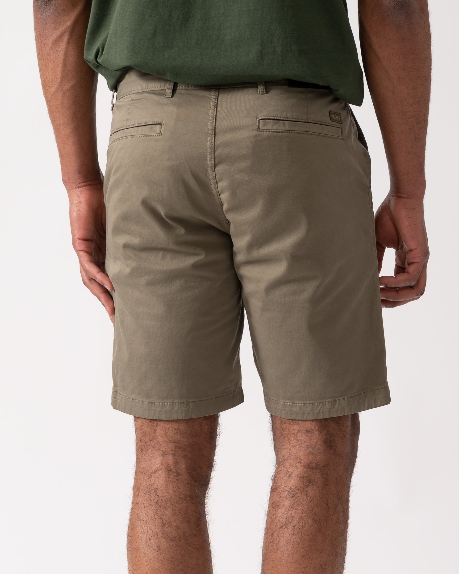 back shot of model wearing BOSS Orange Mens Slim Fit Chino Shorts in Stretch Cotton Twill, Open Green