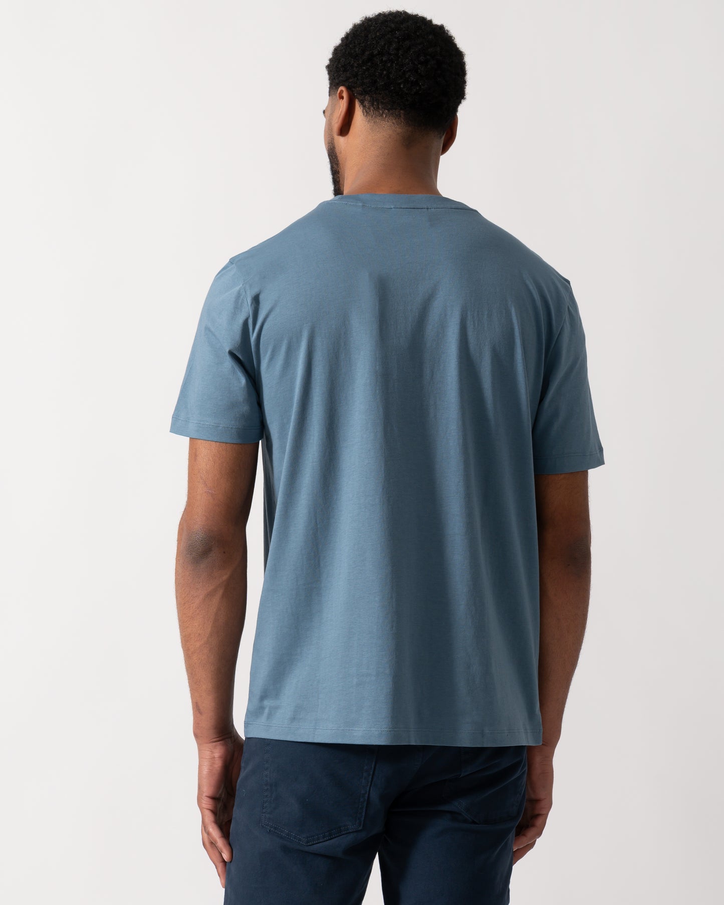 Back shot of a Model wearing a HUGO Dero222 Mens Cotton-Jersey T-Shirt with Logo Print in Open Blue