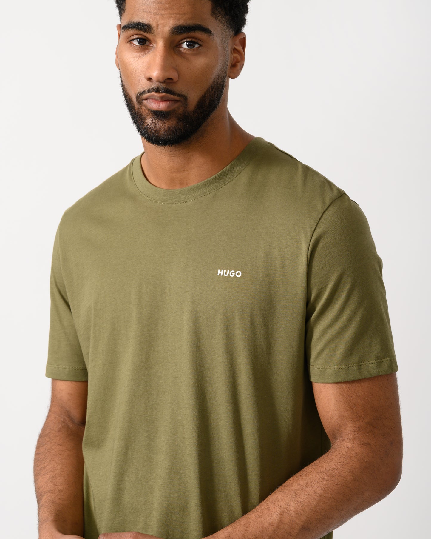 detail shot of a model wearing a HUGO Dero222 Mens Cotton-Jersey T-Shirt with Logo Print in Open Green