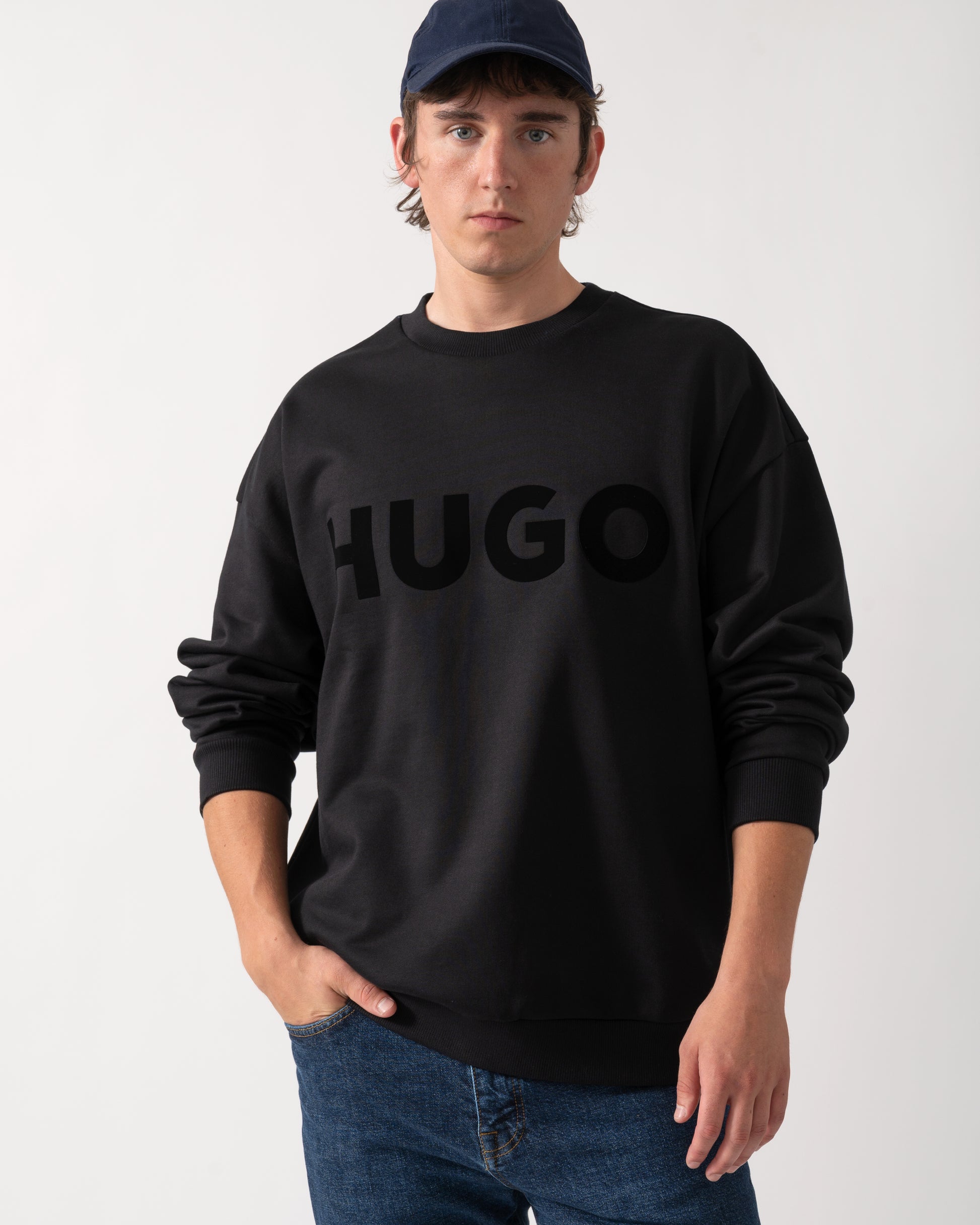 shot of a model wearing a HUGO Dinex Mens Oversized-Fit Sweatshirt in Cotton Terry with Tonal Logo in Black 001