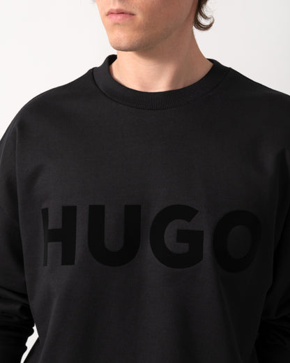 close up shot of a model wearing a HUGO Dinex Mens Oversized-Fit Sweatshirt in Cotton Terry with Tonal Logo in Black 001