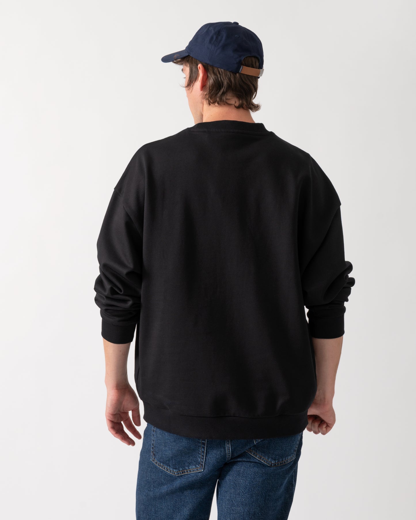 back shot of a model wearing a HUGO Dinex Mens Oversized-Fit Sweatshirt in Cotton Terry with Tonal Logo in Black 001