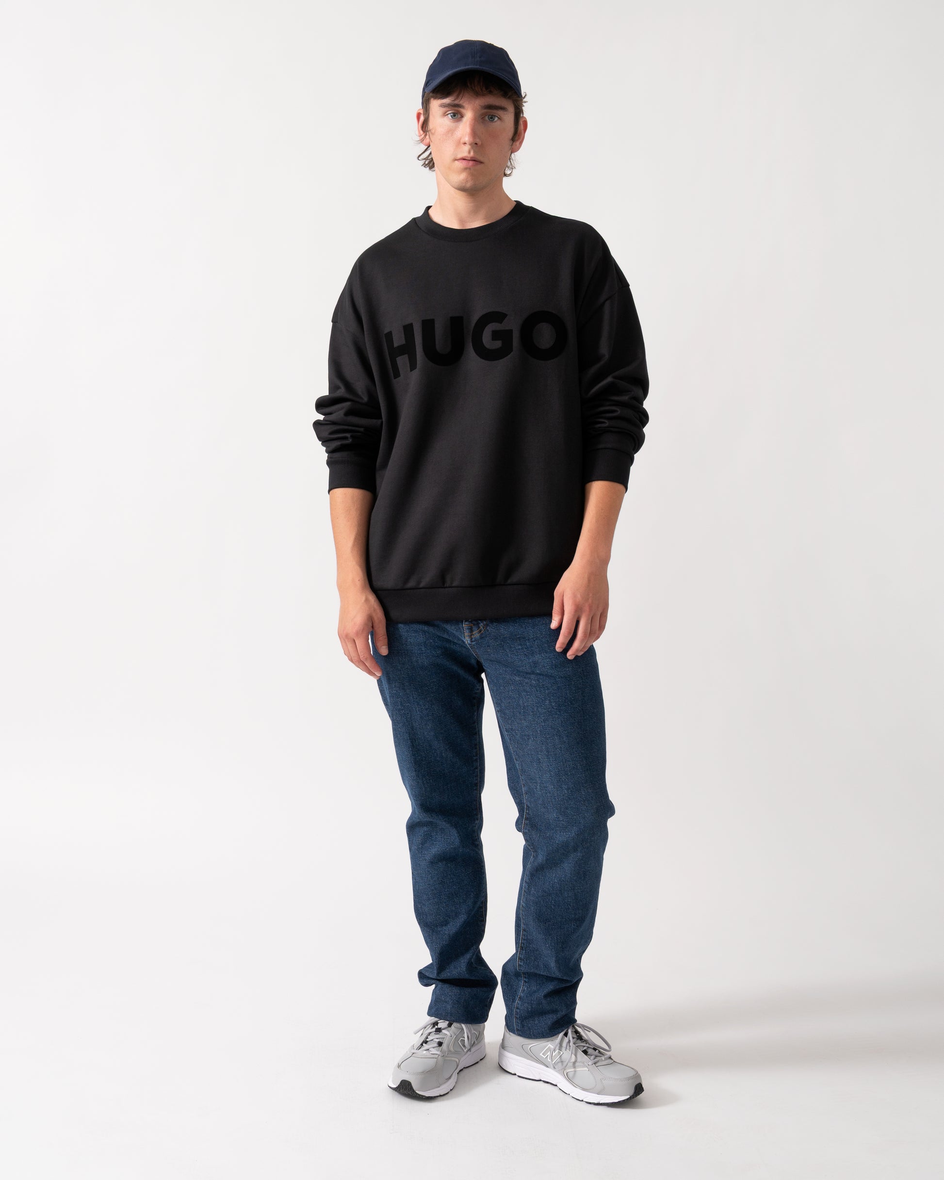 full length shot of a model wearing a HUGO Dinex Mens Oversized-Fit Sweatshirt in Cotton Terry with Tonal Logo in Black 001