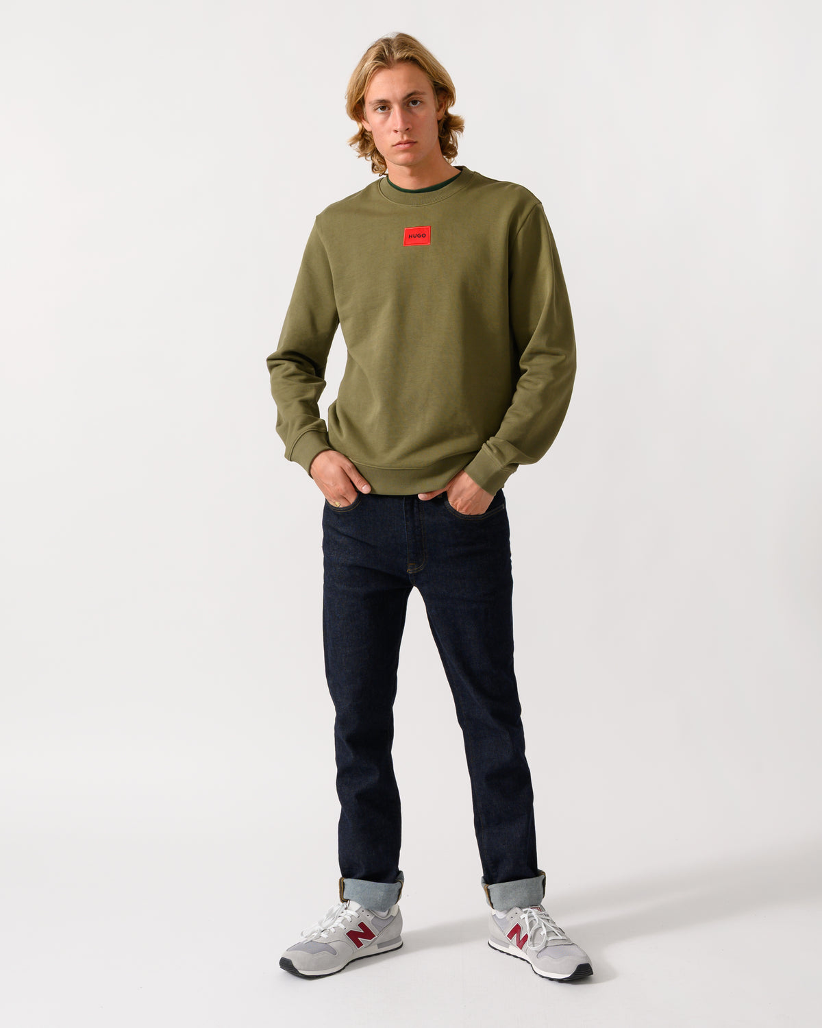 full length of a model wearing a HUGO Diragol212 Label Logo Mens Sweatshirt in Open Green 389