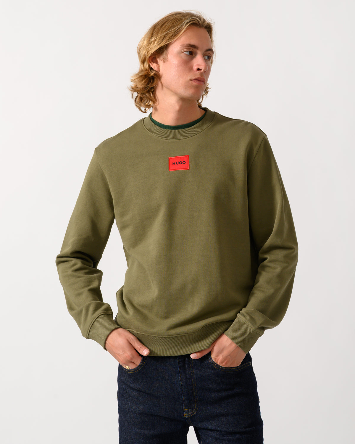 model wearing a HUGO Diragol212 Label Logo Mens Sweatshirt in Open Green 389