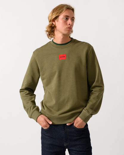 model wearing a HUGO Diragol212 Label Logo Mens Sweatshirt in Open Green 389