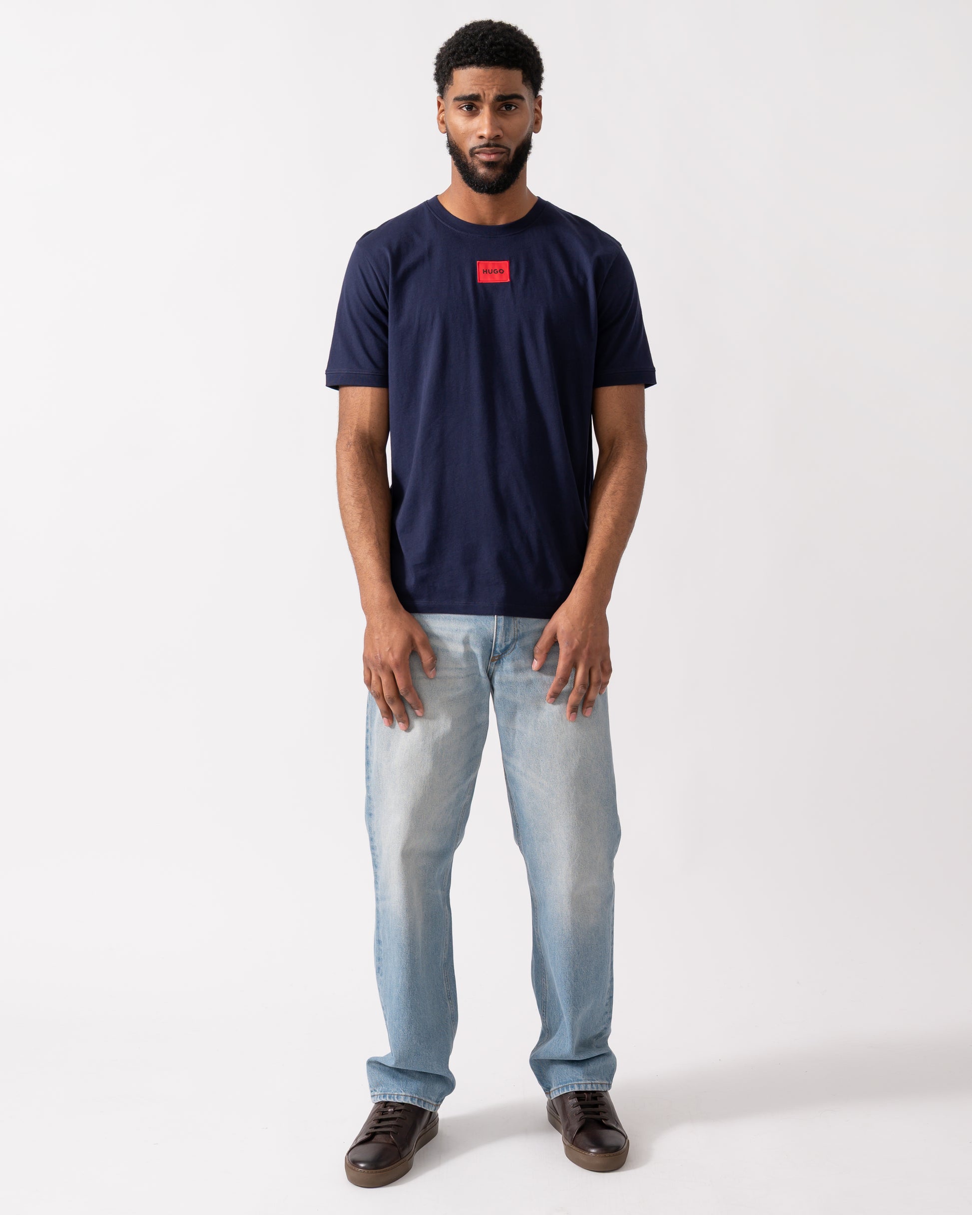 full length of a model wearing a HUGO Diragolino212 Label Logo Mens T-Shirt in Navy