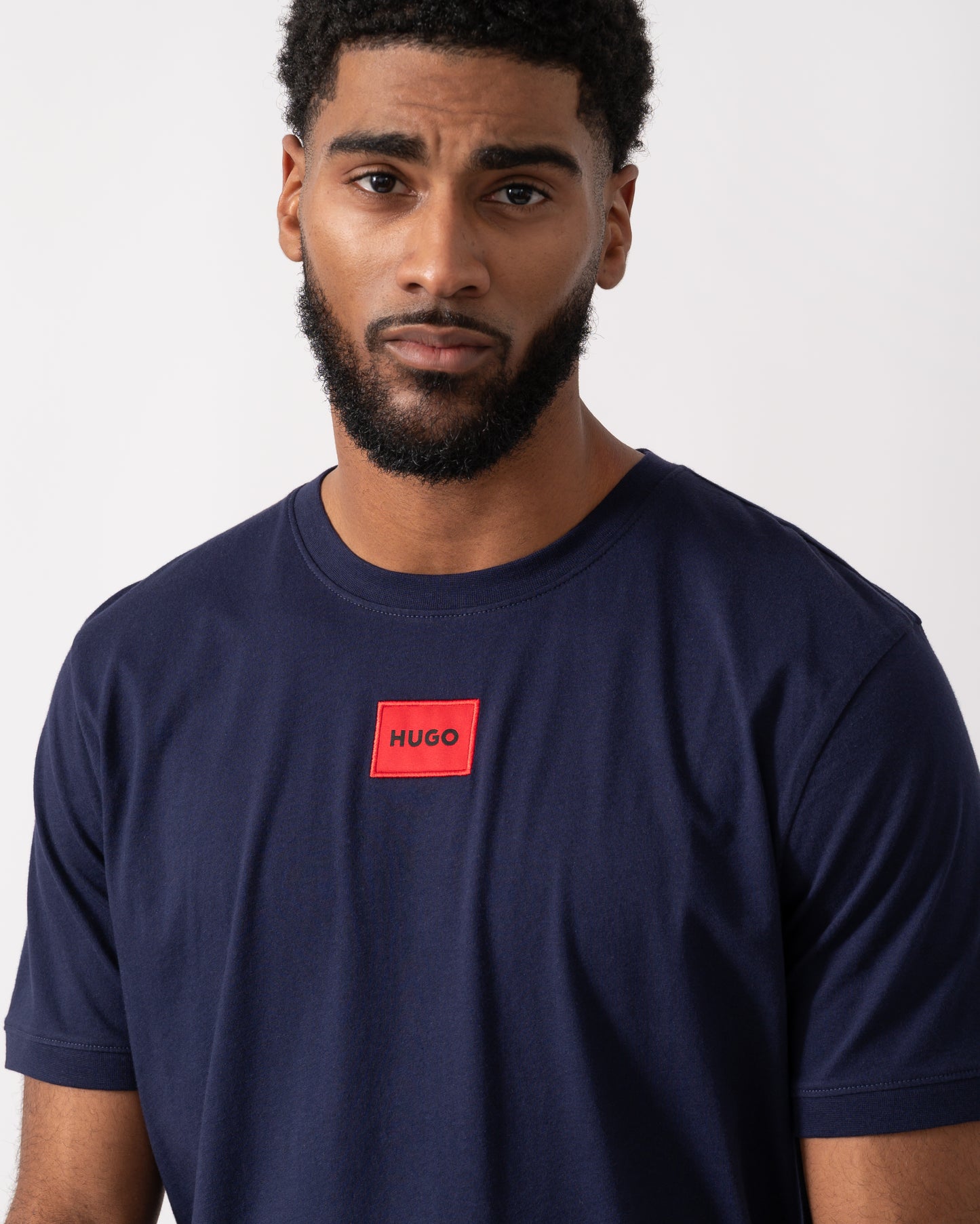 close up of a model wearing a HUGO Diragolino212 Label Logo Mens T-Shirt in Navy