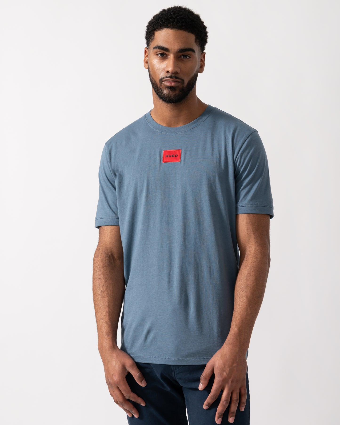 Model wearing a HUGO Diragolino212 Label Logo Mens T-Shirt in Open Blue