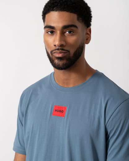 Detail shot of a Model wearing a HUGO Diragolino212 Label Logo Mens T-Shirt in Open Blue