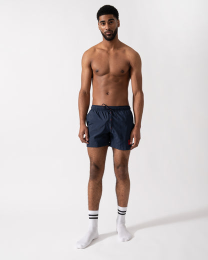 Full length shot of a Model wearing a HUGO Dominica Mens Quick-Drying Swim Shorts In Recycled Material With Logo in Dark Blue