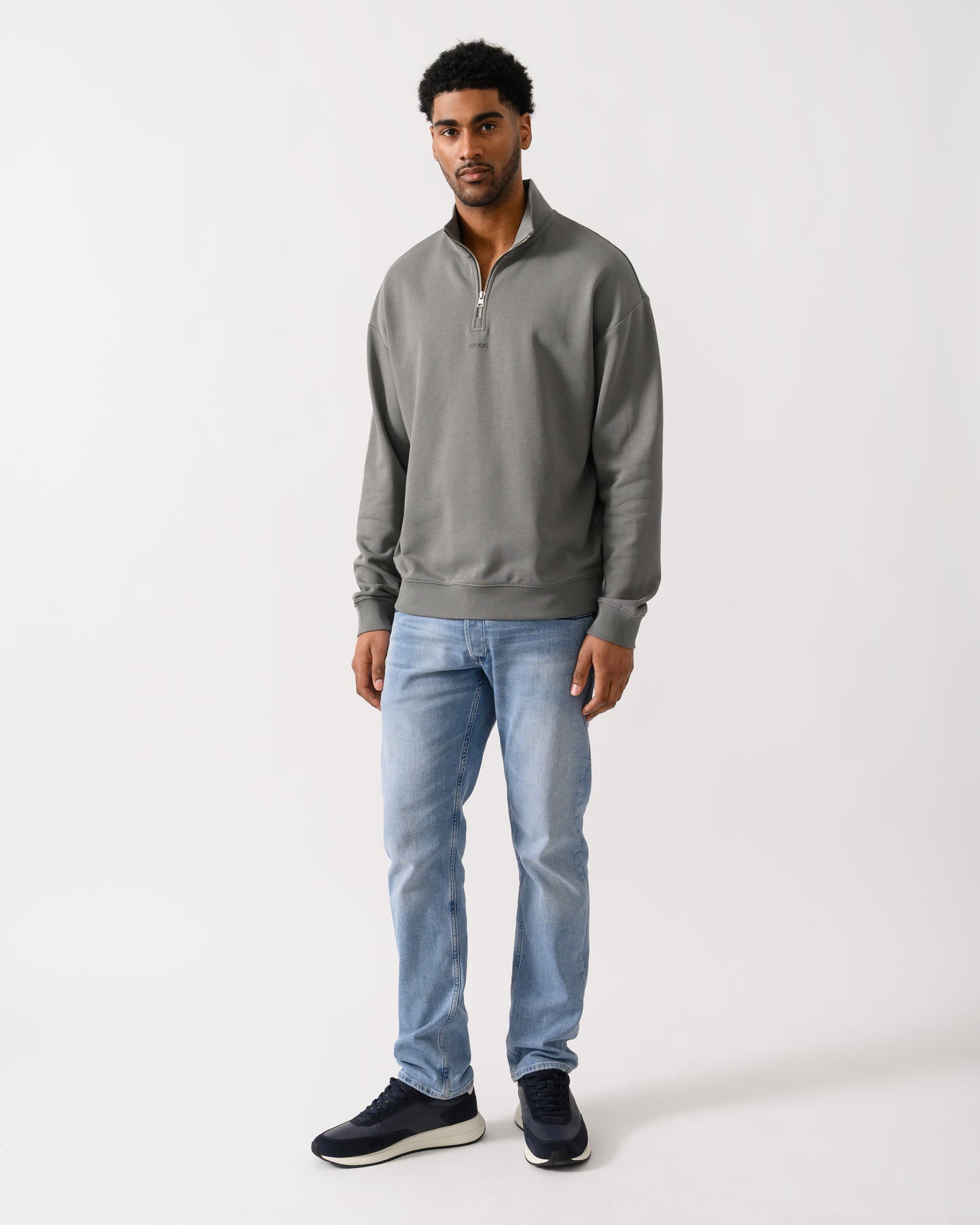full length shot of a model wearing a HUGO Durty244 Mens 1/4 Zip Sweatshirt in Dark Grey 025