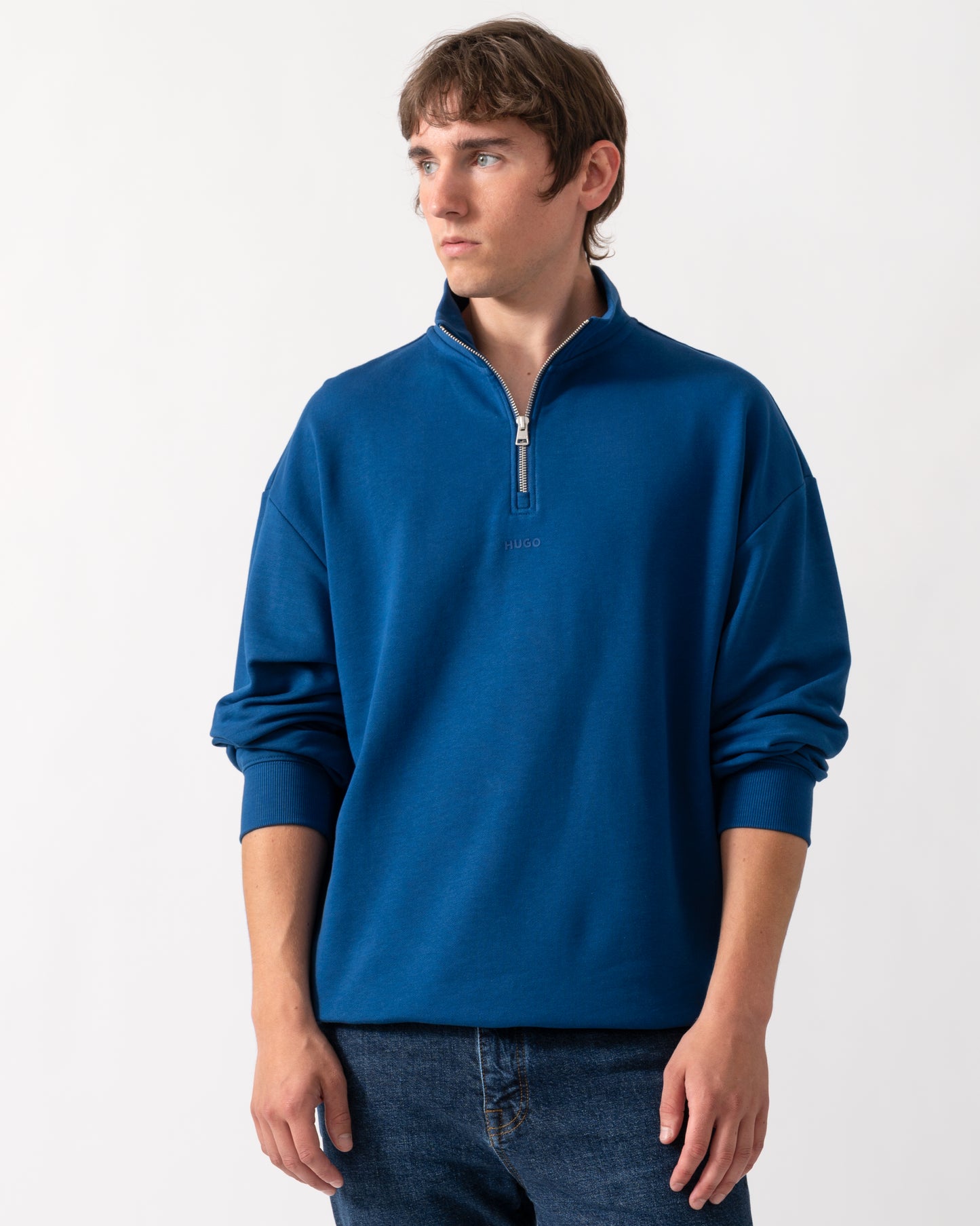model wearing a HUGO Durty244 Mens 1/4 Zip Sweatshirt in Open Blue 498