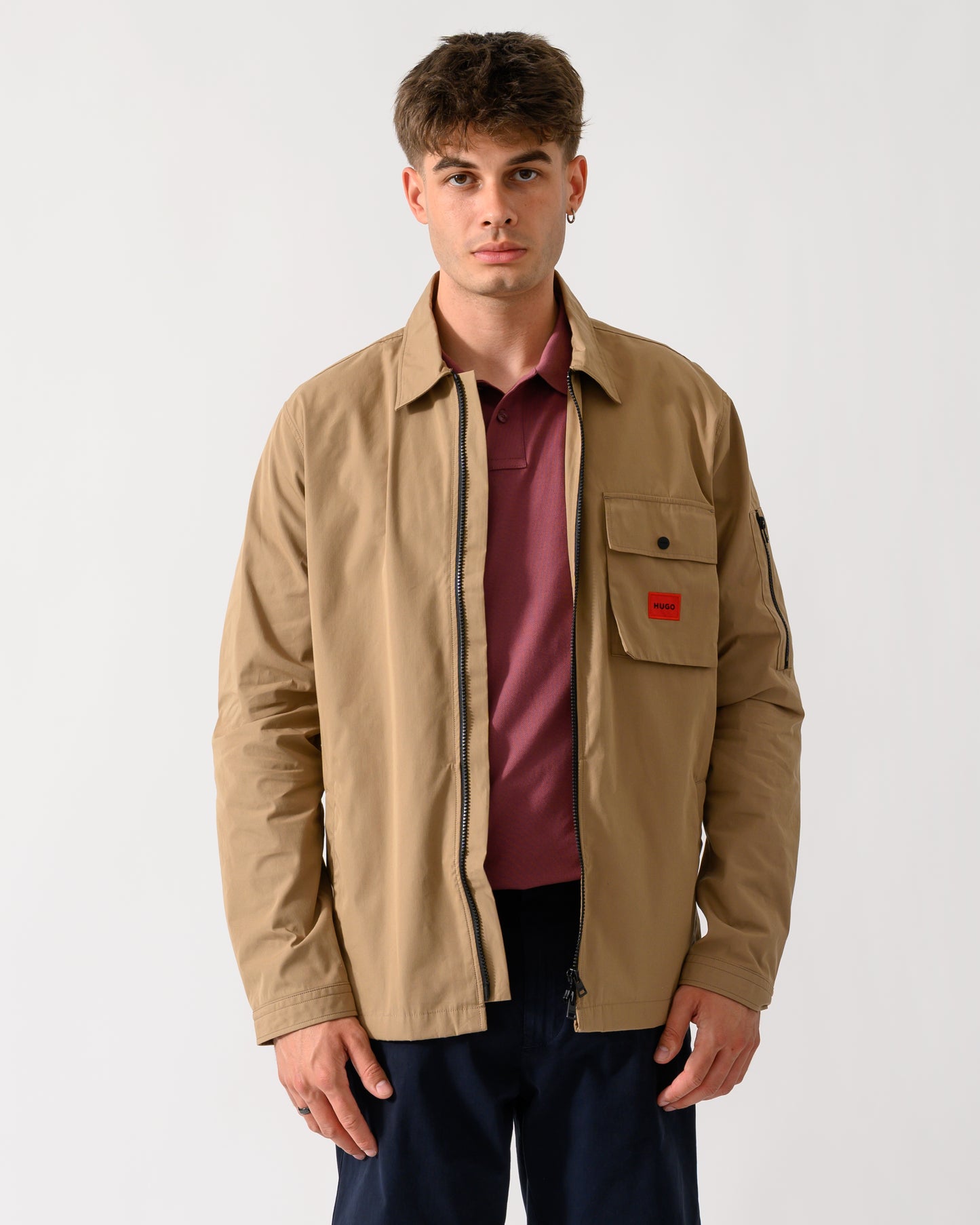 wide shot of a model wearing a HUGO Emmond Mens Zip Overshirt in Beige Overflow 928