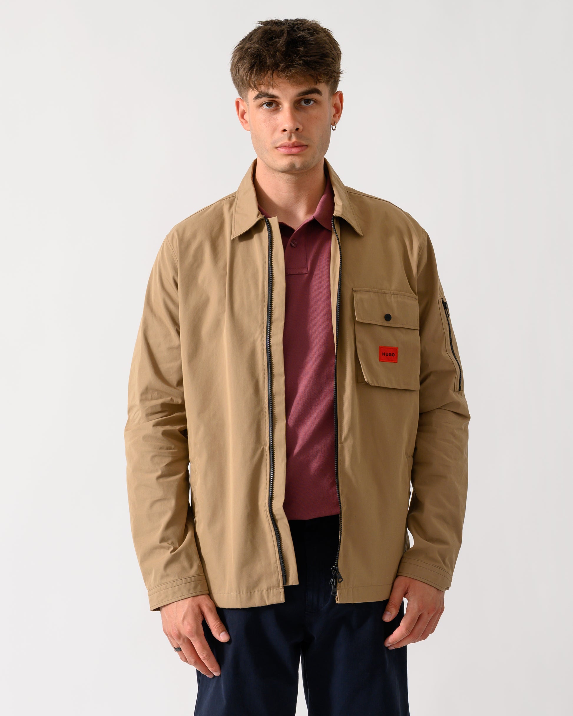 wide shot of a model wearing a HUGO Emmond Mens Zip Overshirt in Beige Overflow 928
