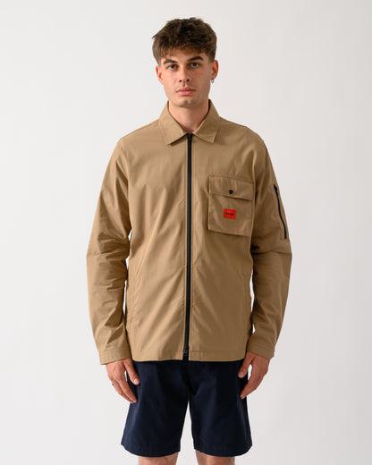 model wearing a HUGO Emmond Mens Zip Overshirt in Beige Overflow 928
