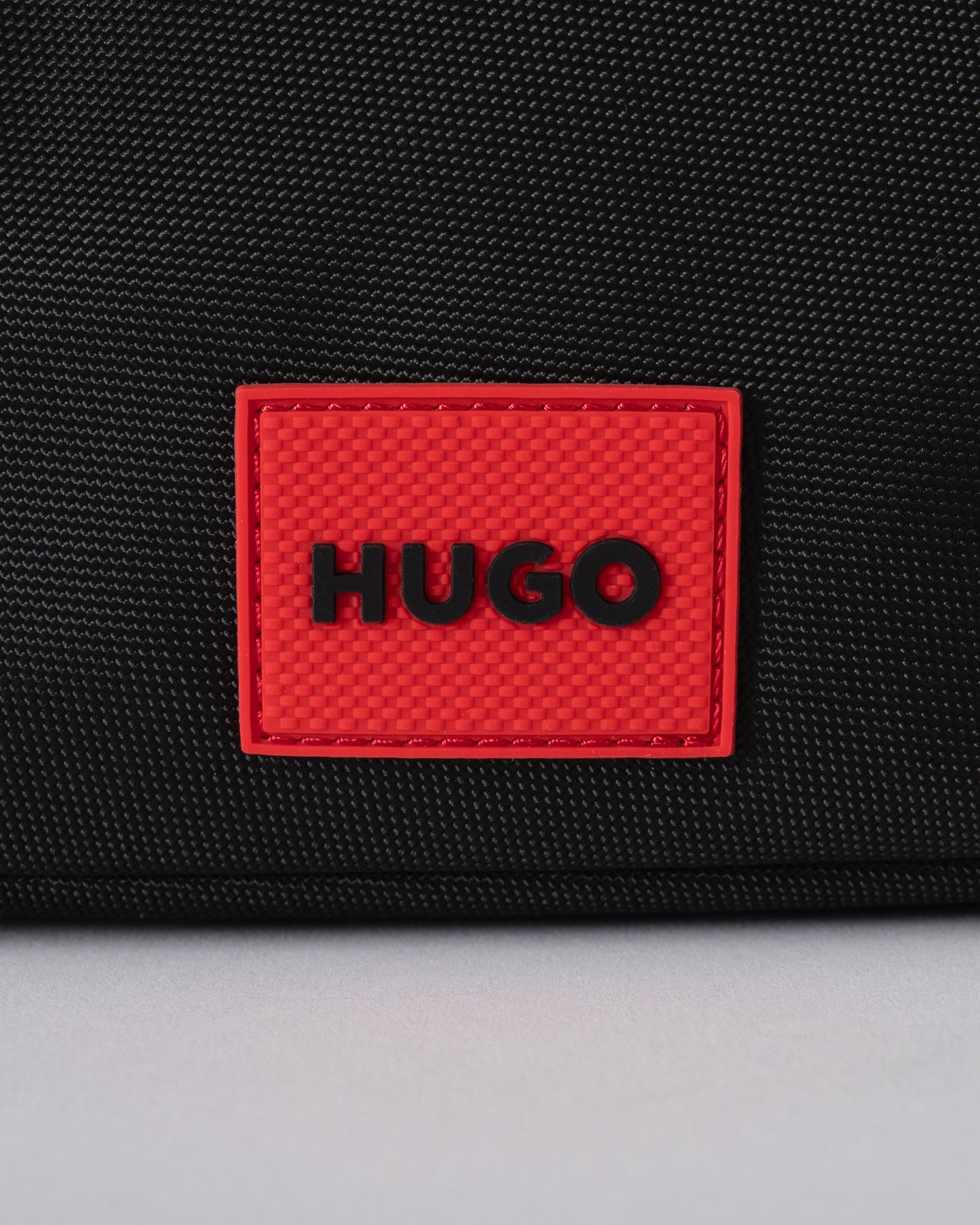 logo detail of a HUGO Ethon 3.0 Mens Crossbody Bag in Black