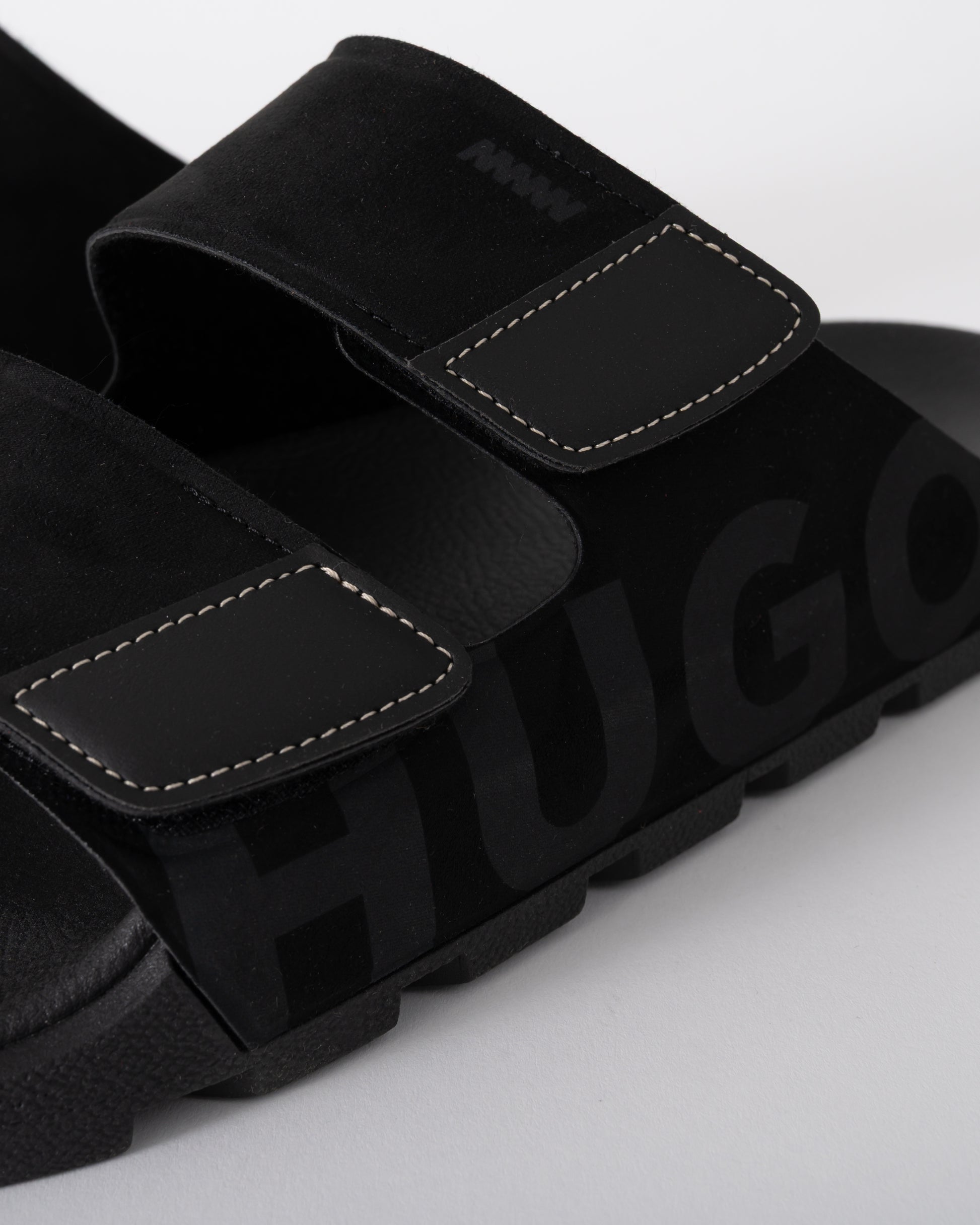 close up shot of HUGO Evander Mens Faux-Suede lides with Logo Detailing in Black