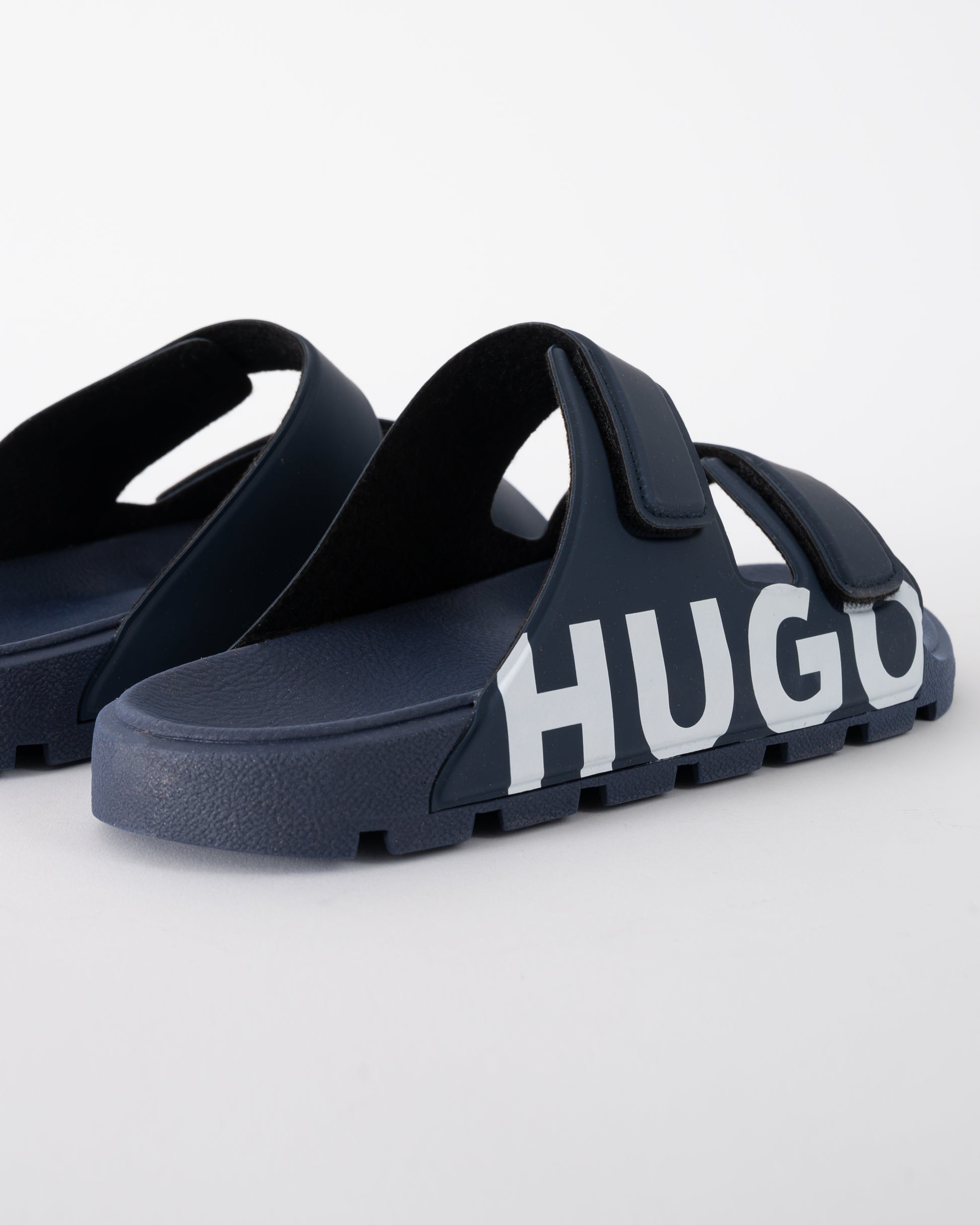 logo detail shot of HUGO Evander Mens Logo Sandals with Double Touch-Closure Straps in Dark Blue