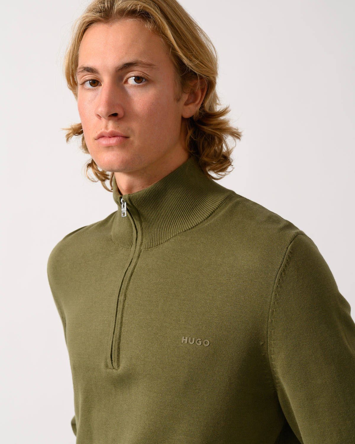 colose up of a model wearing a HUGO San Quintus-C2 Mens 1/4 Zip Funnel Neck Jumper - Open Green 389