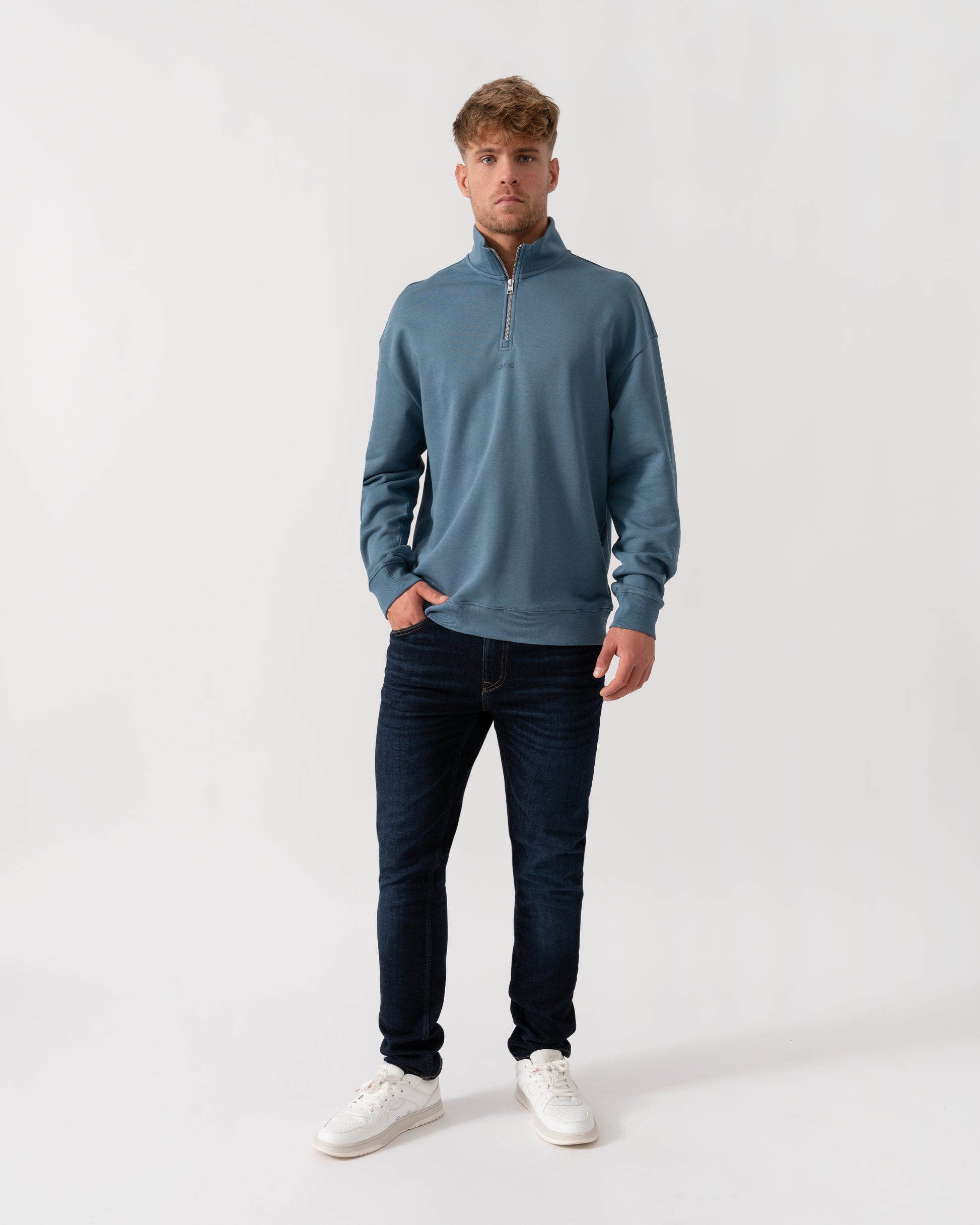 Model wearing HUGO Durty244 Mens 1/4 Zip Sweatshirt in Open Blue 496 - Full Length