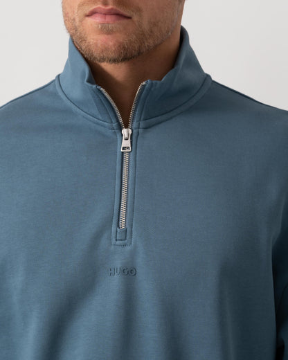 Model wearing HUGO Durty244 Mens 1/4 Zip Sweatshirt in Open Blue 496 - Neck Detail